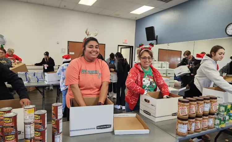 Two woman sorting food for Catalyst Christmas event