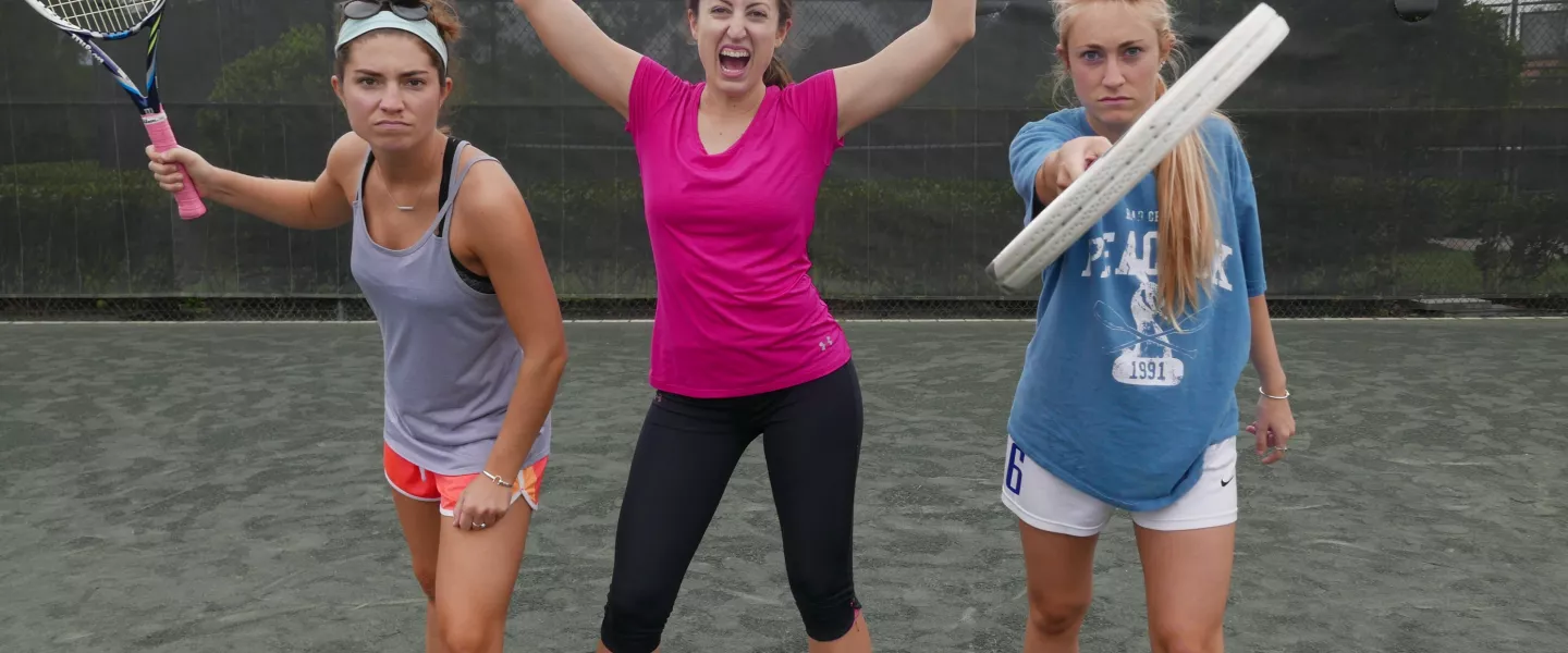 three women on tennis court