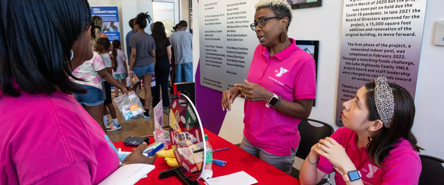 Female YMCA Community Health Instructor talking to a woman